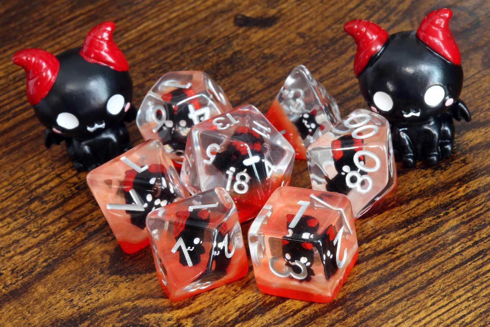 Demonic Cat dice set - Dice set with winged cats on an orange layer - The Wizard's Vault